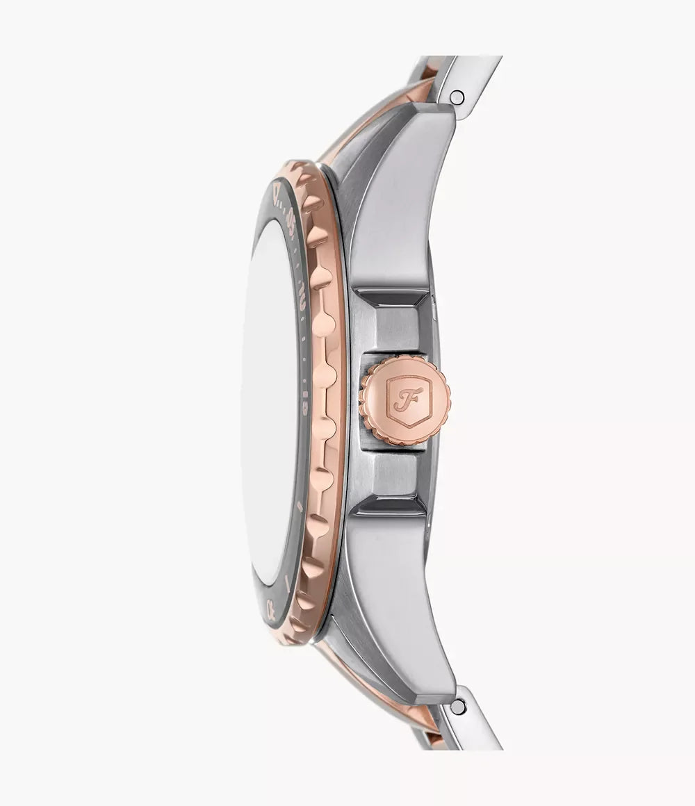Fossil ES5348 side profile – slim two-tone stainless steel case with rose gold-tone crown, showcasing the watch’s refined silhouette – premium craftsmanship by HEY WATCH.