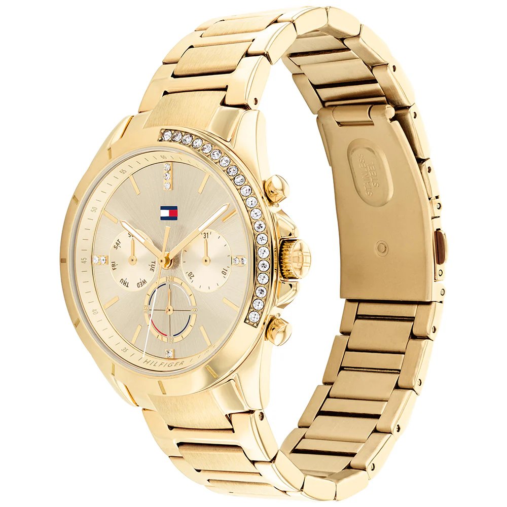 Tommy Hilfiger 1782385 angled view – elegant gold-tone case with crystal accents and gold sunray dial – women’s watch by HEY WATCH.